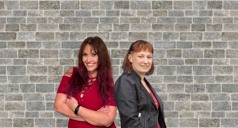 Jayme Blasiman and Chasidy Rae Sisk standing together in front of a brick wall